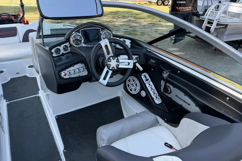 Slide: The Image of 2011 MasterCraft X-35 boat interior with steering wheel and dashboard controls. - 35