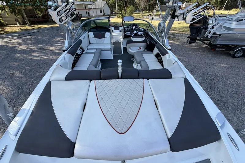 Slide: The Image of 2011 MasterCraft X-35 boat interior with seating and wakeboard racks. - 10