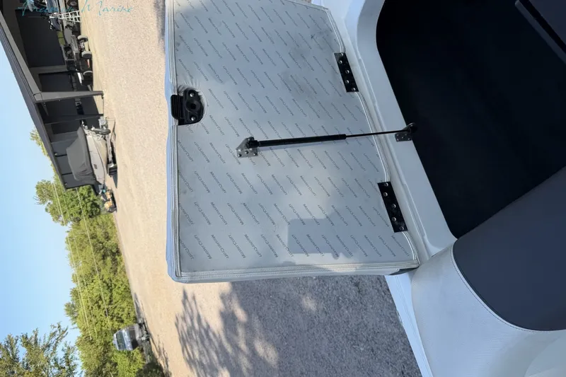 Slide: The Image of 2011 MasterCraft X-35 boat compartment with open hatch and hydraulic support. - 21