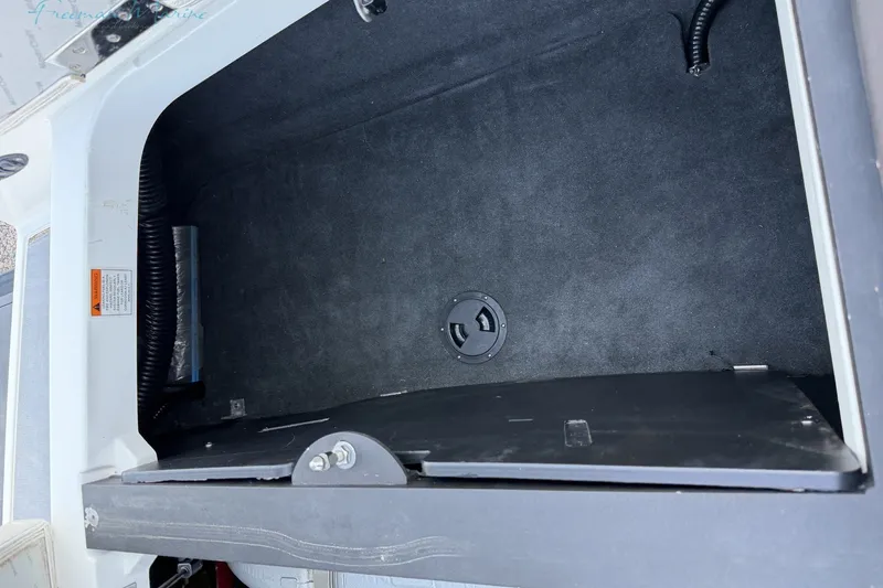 Slide: The Image of Storage compartment of a 2011 MasterCraft X-35 boat, featuring a clean, spacious interior. - 17