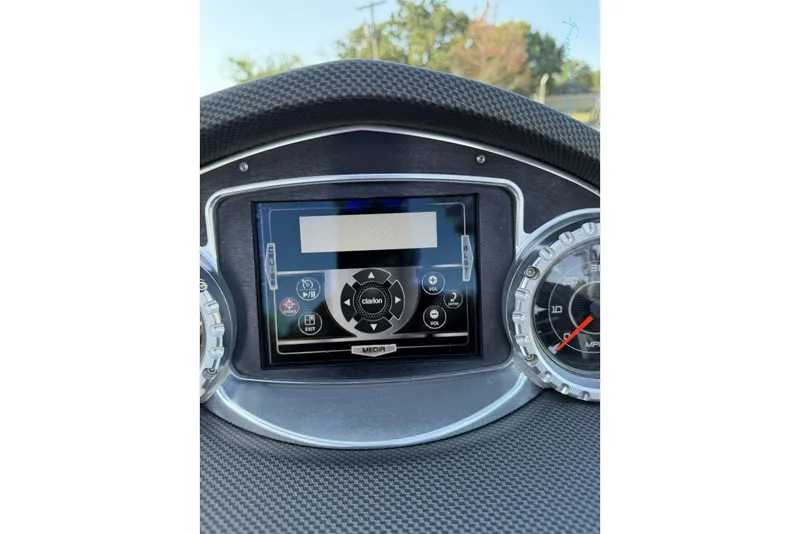 Slide: The Image of Dashboard of a 2011 MasterCraft X-35 boat featuring a Clarion media system. - 42