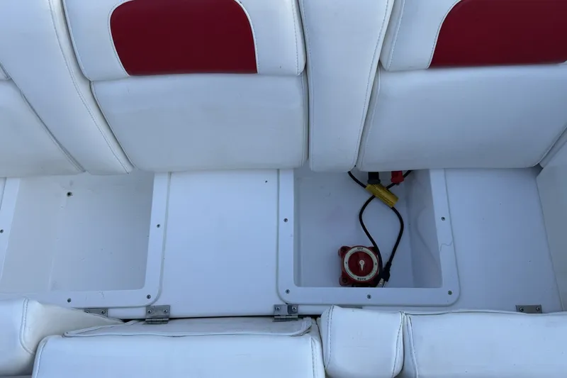 Slide: The Image of White and red boat seating with storage compartment, featuring wiring and a control switch. - 9