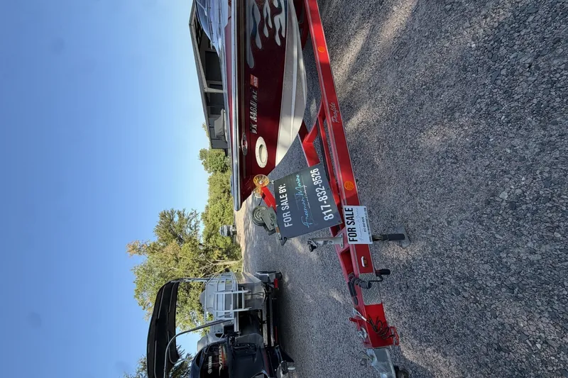 Slide: The Image of Red Profile 260 V boat for sale on trailer, 2006 model, parked outdoors. - 8