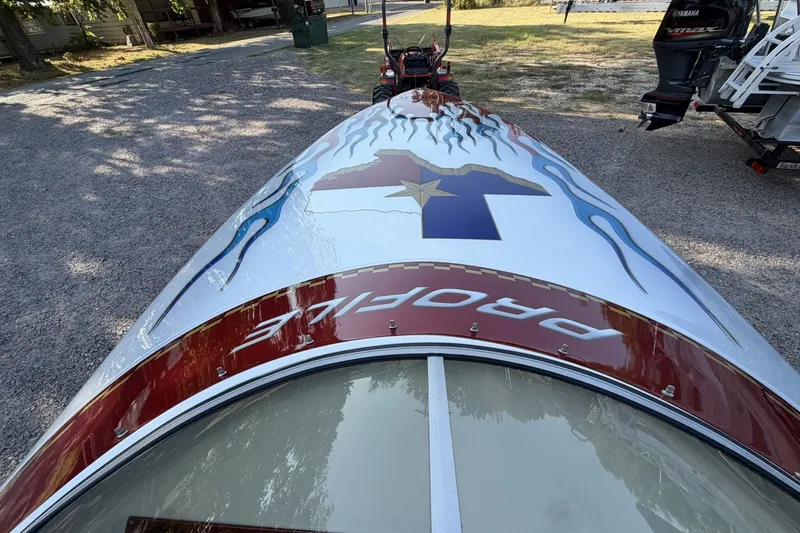 Slide: The Image of 2006 Profile 260 V boat with custom graphics and Yamaha outboard motor. - 20