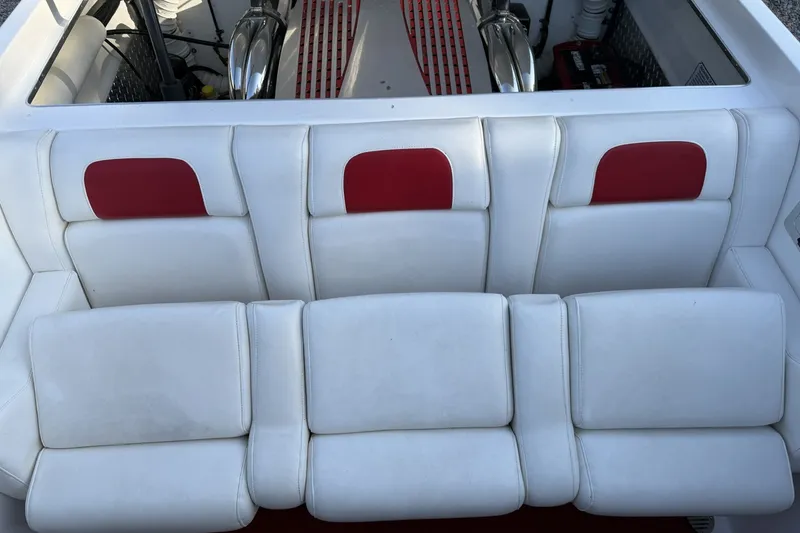 Slide: The Image of White and red seating in a 2006 Profile 260 V boat interior. - 13