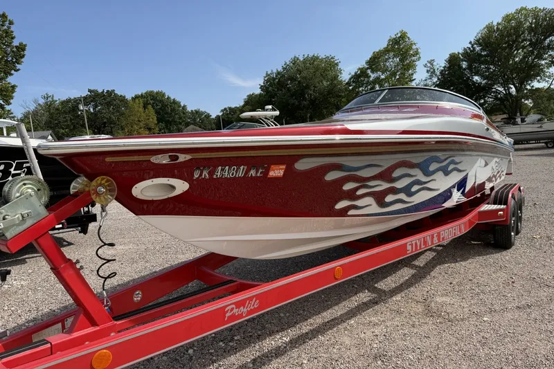 Slide: The Image of Red and white 2006 Profile 260 V boat on trailer with flame graphics. - 6