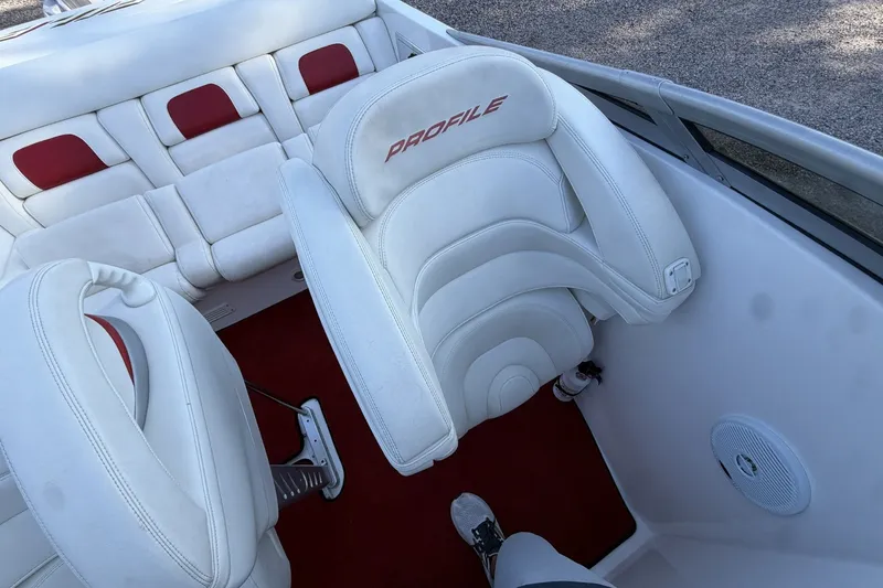 Slide: The Image of Interior of a 2006 Profile 260 V boat with white and red seating. - 22