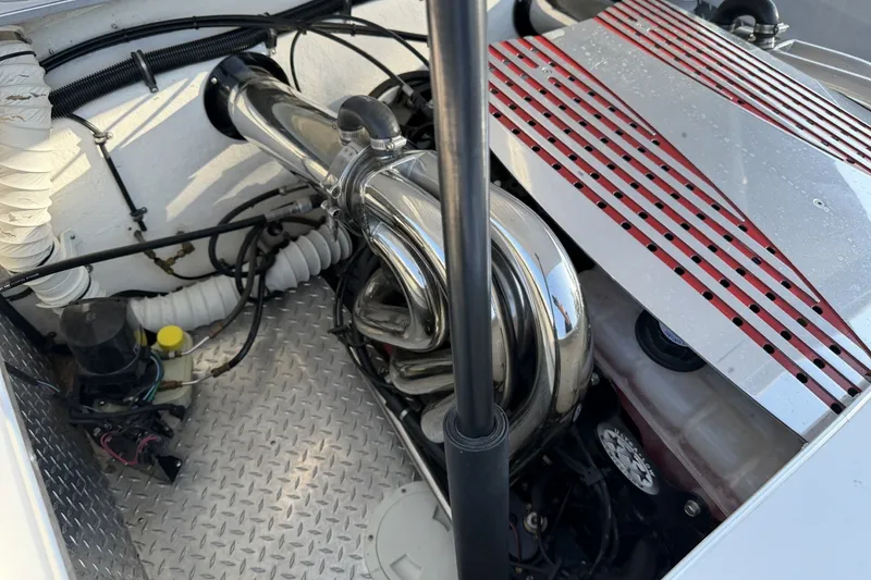 Slide: The Image of Engine compartment of a 2006 Profile 260 V boat with chrome exhaust pipes. - 11