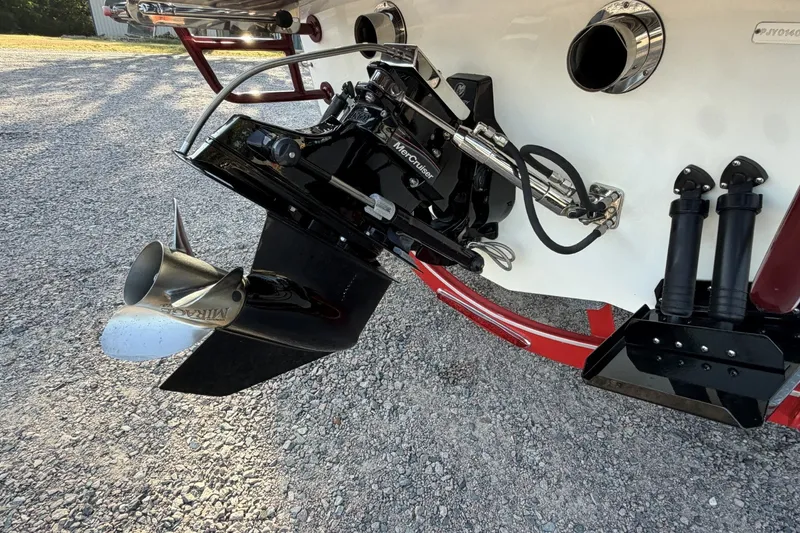 Slide: The Image of Boat engine with MerCruiser outdrive and Mirage propeller on gravel surface. - 30