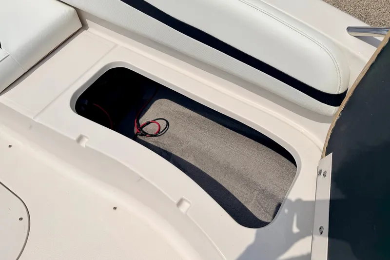 Slide: The Image of Storage compartment in 2008 Starcraft 2000 IO Limited boat, featuring white seating and wiring. - 49