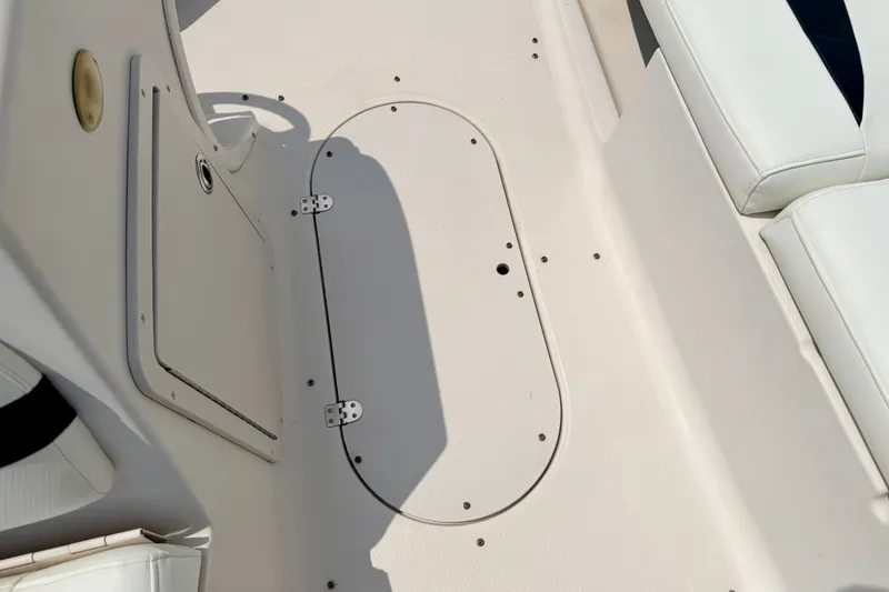 Slide: The Image of Interior view of a 2008 Starcraft 2000 IO Limited boat, featuring seating and storage hatch. - 53