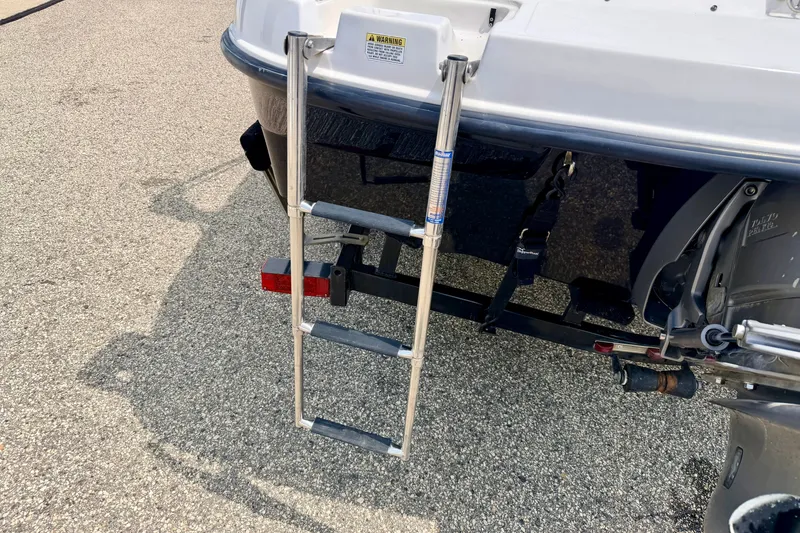 Slide: The Image of Rear view of 2008 Starcraft 2000 IO Limited boat with ladder and motor. - 20