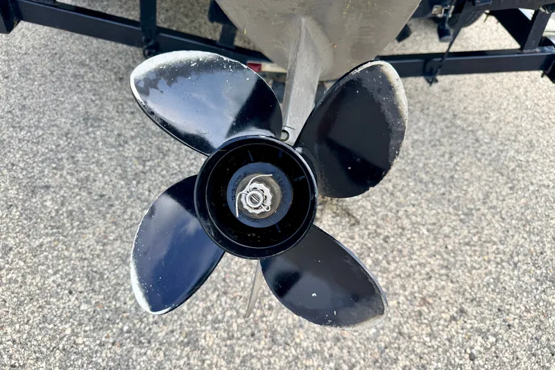 Slide: The Image of Close-up of a 2008 Starcraft 2000 IO Limited boat propeller on asphalt. - 17