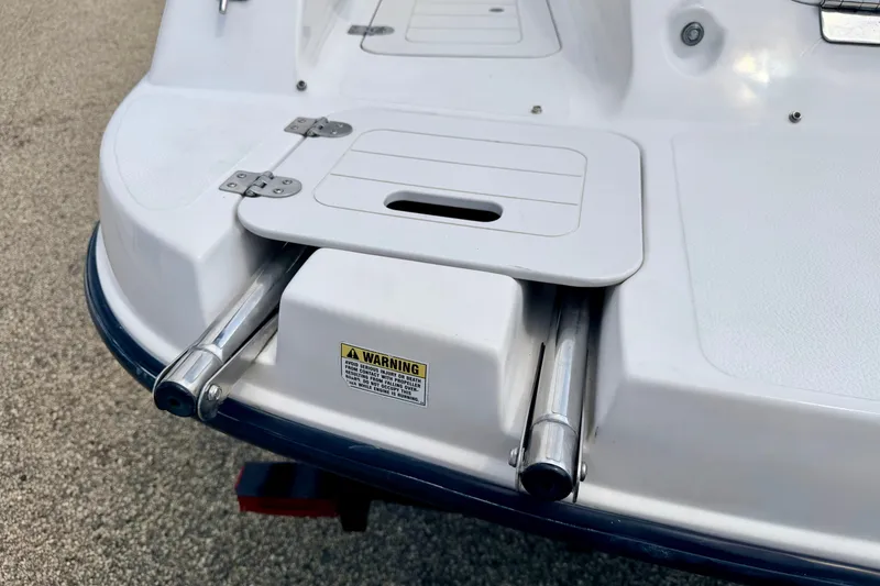 Slide: The Image of 2008 Starcraft 2000 IO Limited boat swim platform with retractable ladder and warning label. - 19