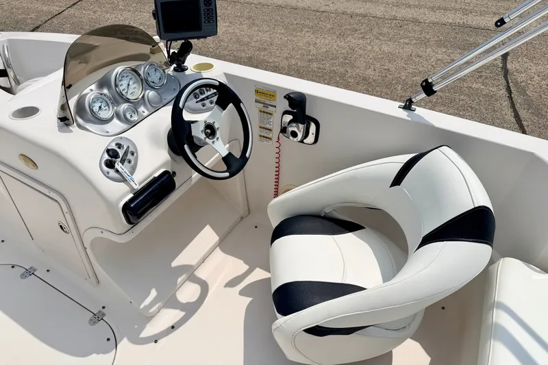 Slide: The Image of 2008 Starcraft 2000 IO Limited boat cockpit with steering wheel and gauges. - 33