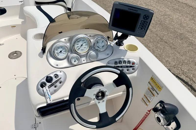 Slide: The Image of 2008 Starcraft 2000 IO Limited boat dashboard with steering wheel and navigation system. - 35