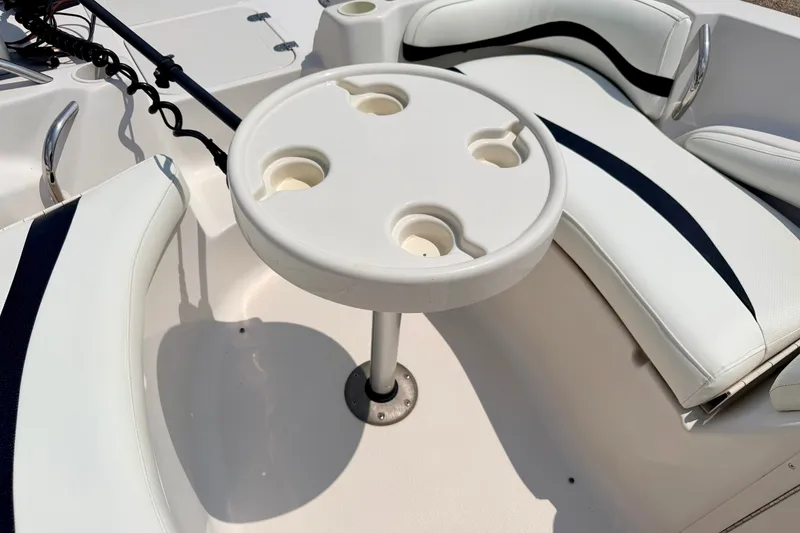Slide: The Image of 2008 Starcraft 2000 IO Limited boat interior with white seating and round table. - 66