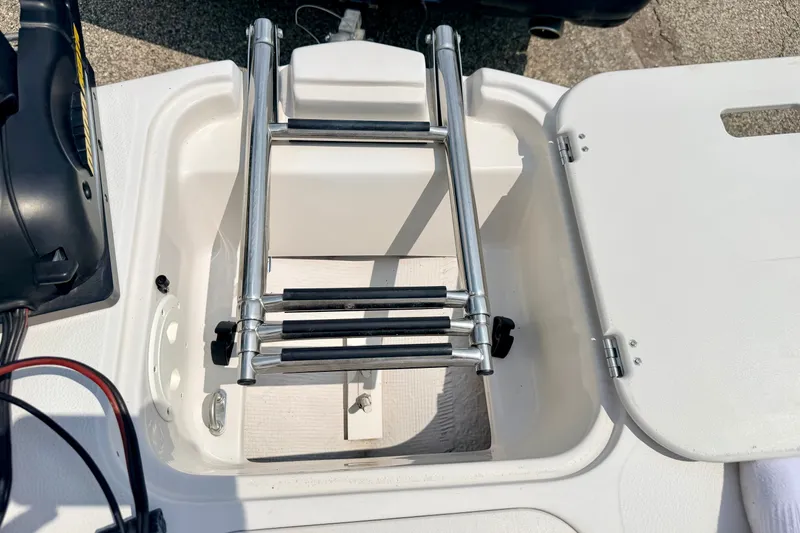 Slide: The Image of 2008 Starcraft 2000 IO Limited boat ladder in open storage compartment. - 64
