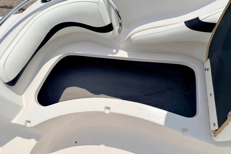 Slide: The Image of 2008 Starcraft 2000 IO Limited boat interior storage compartment with cushioned seating. - 51