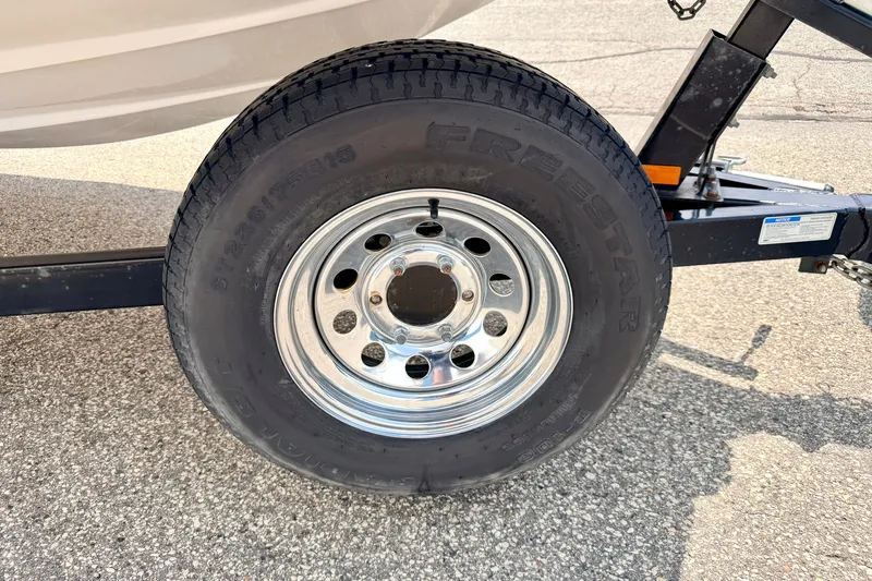 Slide: The Image of Trailer tire of a 2008 Starcraft 2000 IO Limited on asphalt surface. - 81