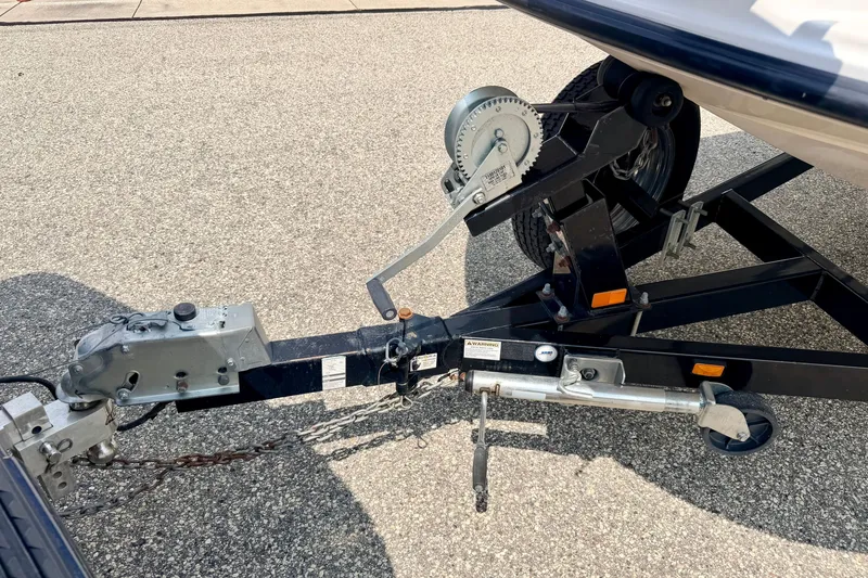 Slide: The Image of Trailer hitch and winch of a 2008 Starcraft 2000 IO Limited boat on pavement. - 73