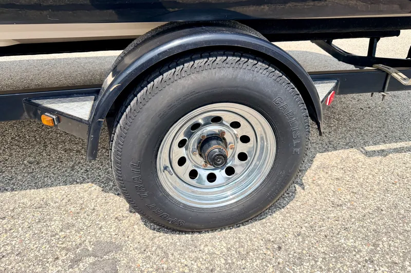 Slide: The Image of Flat tire on a 2008 Starcraft 2000 IO Limited trailer, parked on asphalt. - 75