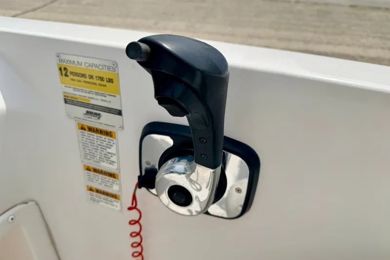 Slide: The Image of Throttle control on a 2008 Starcraft 2000 IO Limited boat, with capacity warning label. - 40