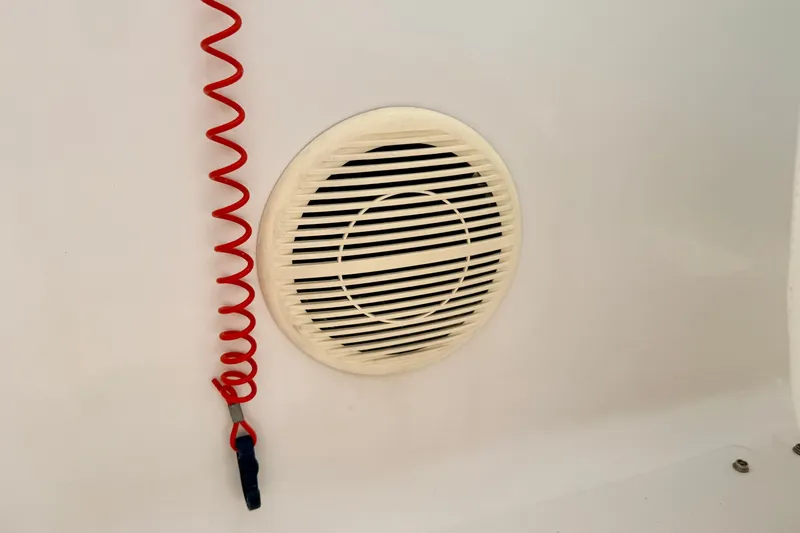 Slide: The Image of Red coiled cord and speaker on 2008 Starcraft 2000 IO Limited boat interior. - 44