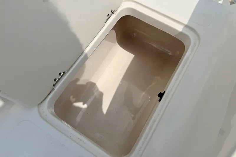 Slide: The Image of Open storage compartment on a 2008 Starcraft 2000 IO Limited boat. - 27