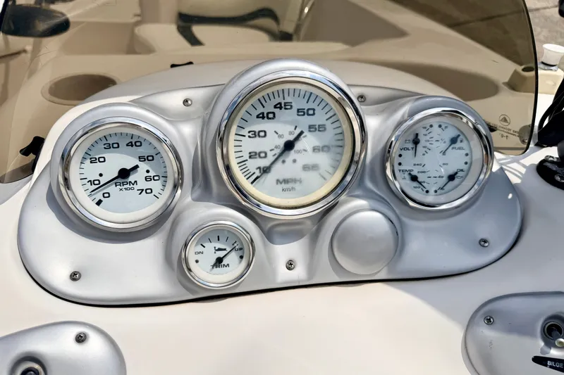Slide: The Image of Dashboard of a 2008 Starcraft 2000 IO Limited boat with gauges and controls. - 36
