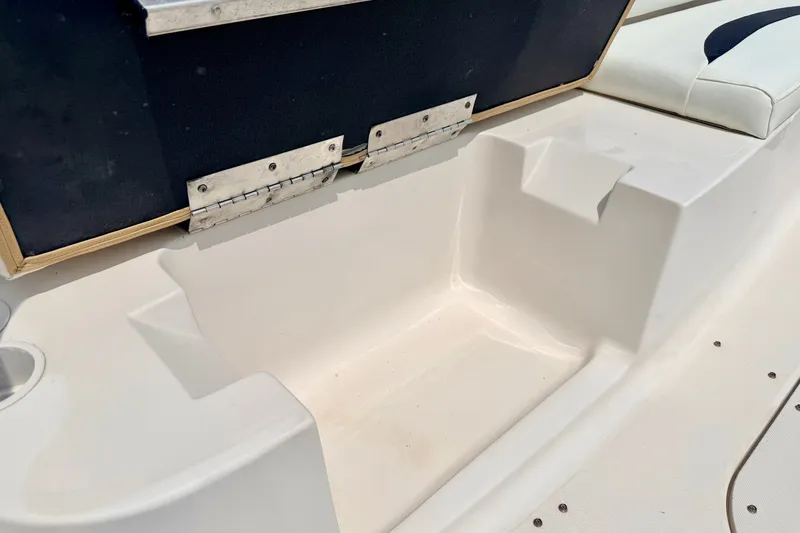 Slide: The Image of 2008 Starcraft 2000 IO Limited boat interior with white seating and storage compartment. - 47
