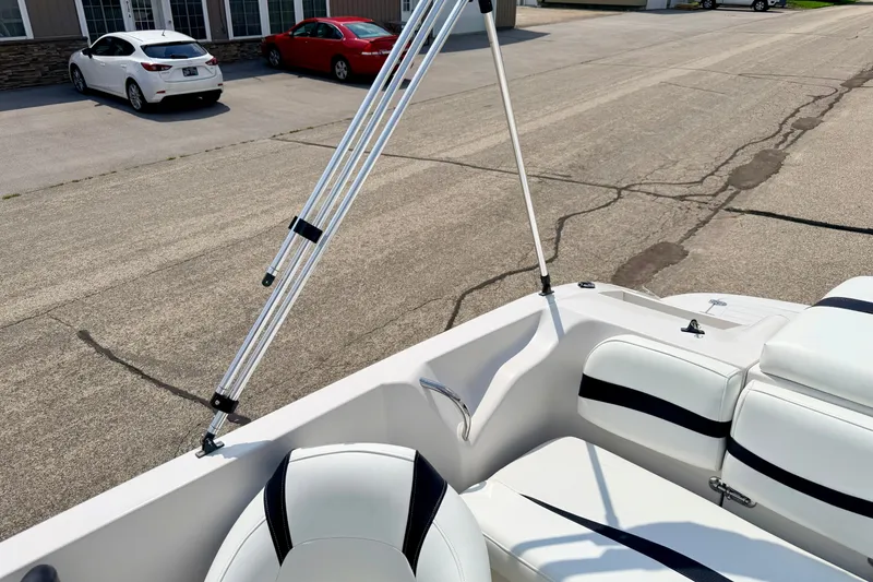 Slide: The Image of 2008 Starcraft 2000 IO Limited boat interior with white seating and support poles. - 68