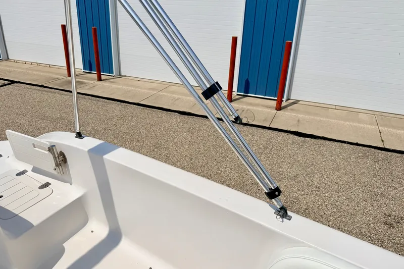 Slide: The Image of 2008 Starcraft 2000 IO Limited boat interior with metal railings and storage compartment. - 69
