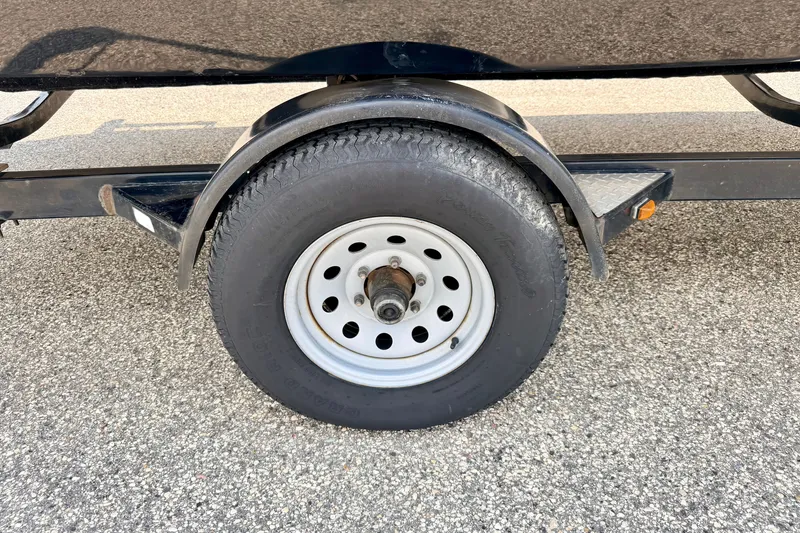 Slide: The Image of Trailer wheel of a 2008 Starcraft 2000 IO Limited on asphalt surface. - 79