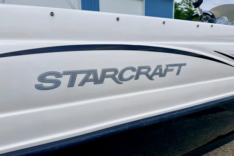 Slide: The Image of 2008 Starcraft 2000 IO Limited boat with logo on white hull. - 13