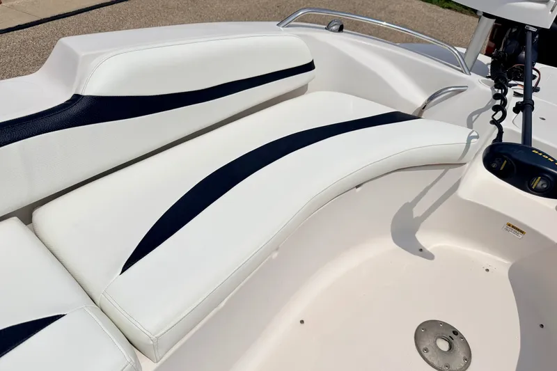 Slide: The Image of 2008 Starcraft 2000 IO Limited boat interior with white and black seating. - 48