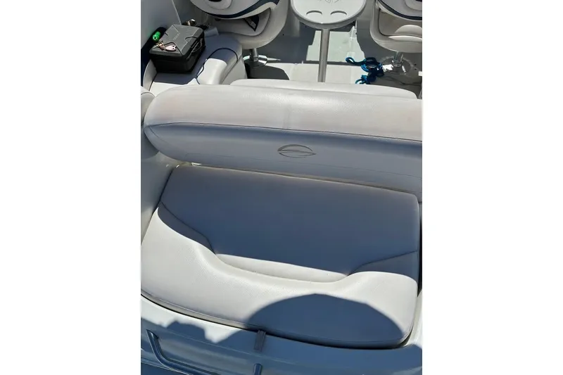 Slide: The Image of Interior seating of a 2012 Crownline 236 SC boat, featuring white upholstery. - 47