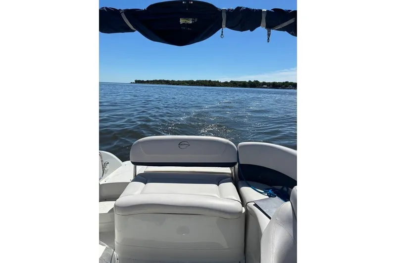 Slide: The Image of 2012 Crownline 236 SC boat on calm water with clear blue sky. - 36