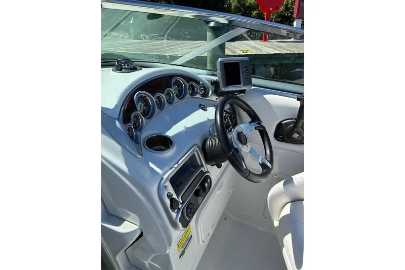 Slide: The Image of 2012 Crownline 236 SC boat dashboard with steering wheel and gauges. - 50