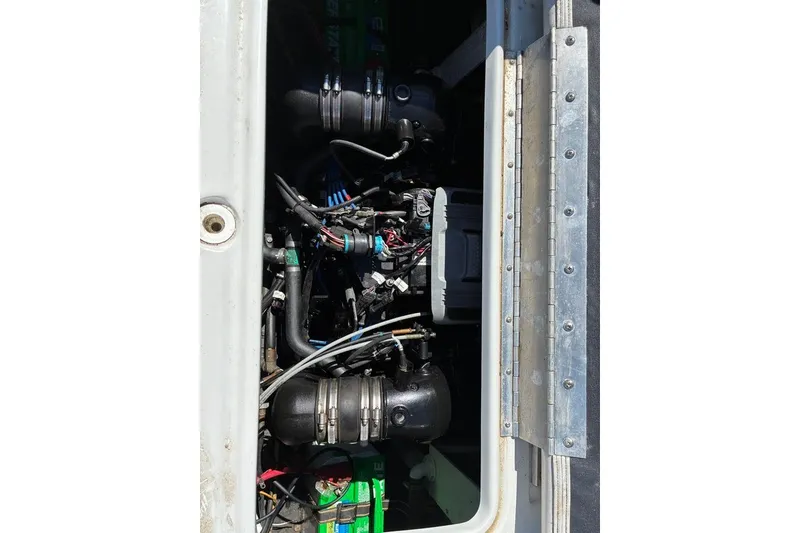 Slide: The Image of Engine compartment of a 2012 Crownline 236 SC boat, showing mechanical components. - 40