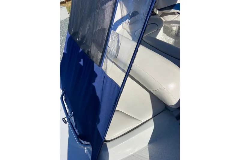 Slide: The Image of 2012 Crownline 236 SC boat interior with blue cover and white seating. - 14