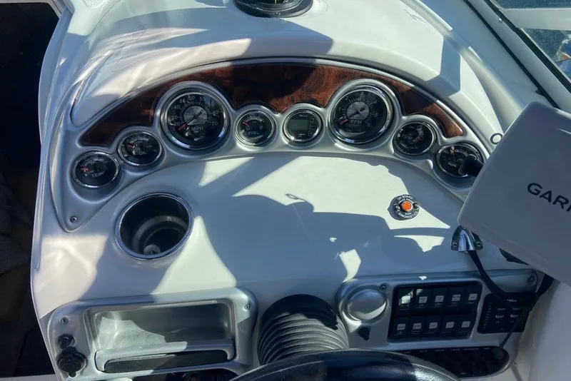 Slide: The Image of Dashboard of a 2012 Crownline 236 SC boat with gauges and controls. - 26