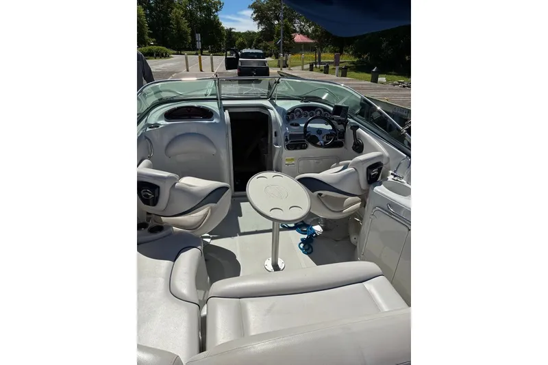 Slide: The Image of Interior of a 2012 Crownline 236 SC boat with seating and steering console. - 48