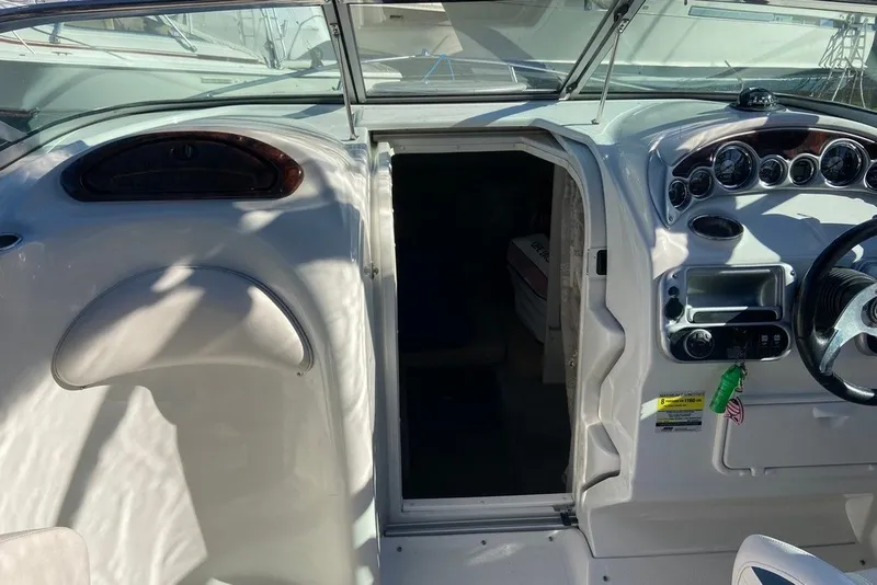 Slide: The Image of 2012 Crownline 236 SC boat interior with steering wheel and dashboard controls. - 19