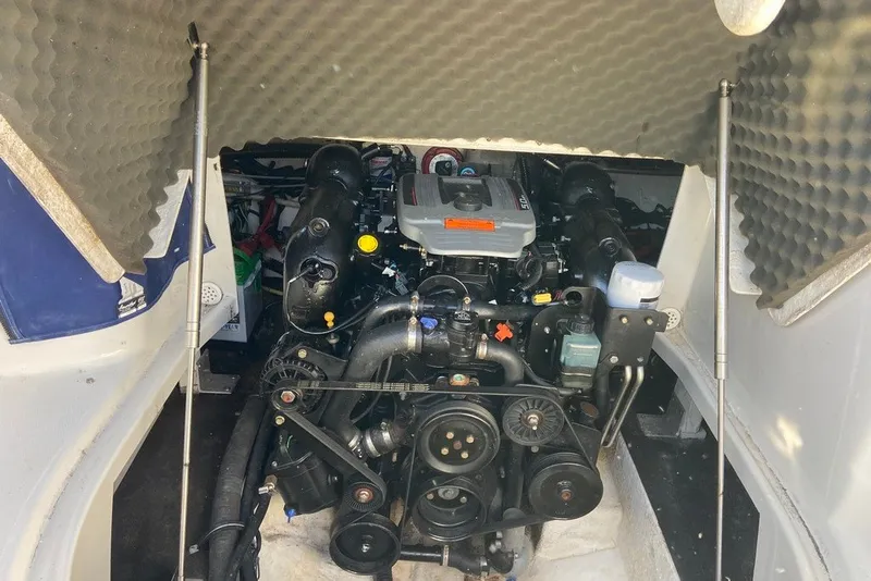 Slide: The Image of Engine compartment of a 2012 Crownline 236 SC boat, showcasing mechanical components. - 27