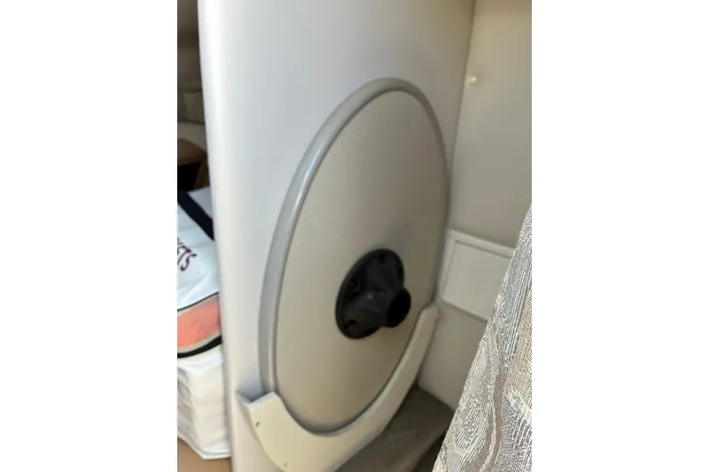Slide: The Image of Interior detail of a 2012 Crownline 236 SC boat, featuring a circular compartment door. - 45