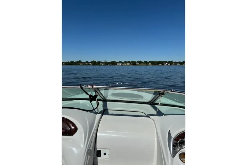 Slide: The Image of 2012 Crownline 236 SC boat on a calm lake under clear blue skies. - 35