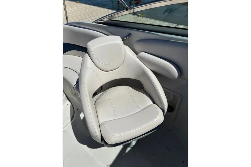 Slide: The Image of White leather seat on 2012 Crownline 236 SC boat, dockside view. - 52