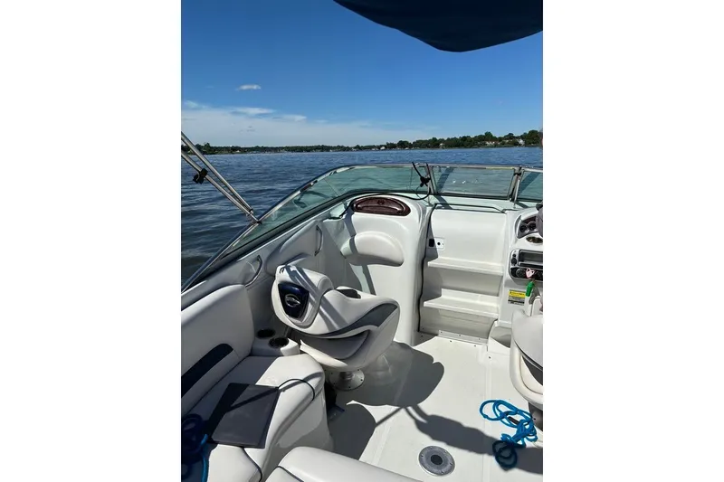 Slide: The Image of 2012 Crownline 236 SC boat interior with steering wheel, seating, and lake view. - 37