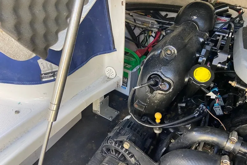 Slide: The Image of Engine compartment of a 2012 Crownline 236 SC boat, showing mechanical components. - 29
